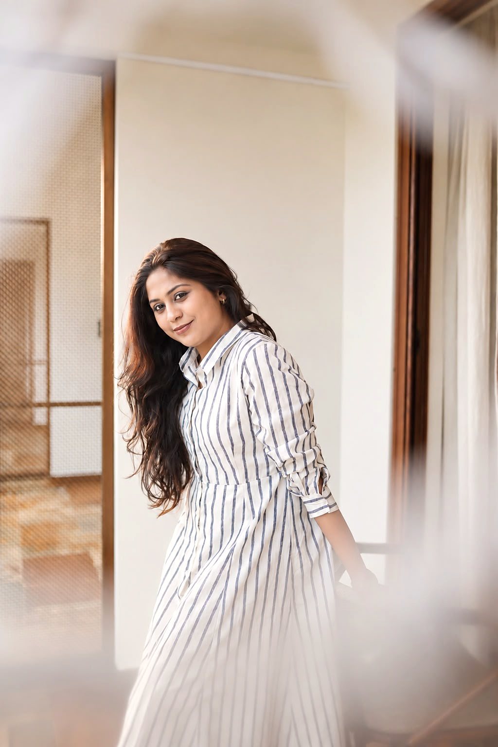 Dr. Aiswaryia Mohan in a striped dress