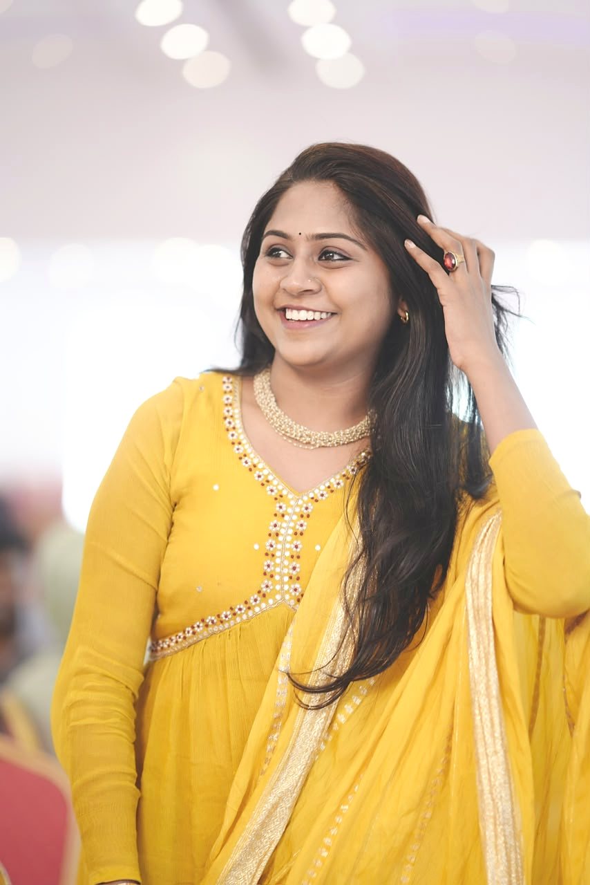 Dr. Aiswaryia Mohan smiling at an event in yellow